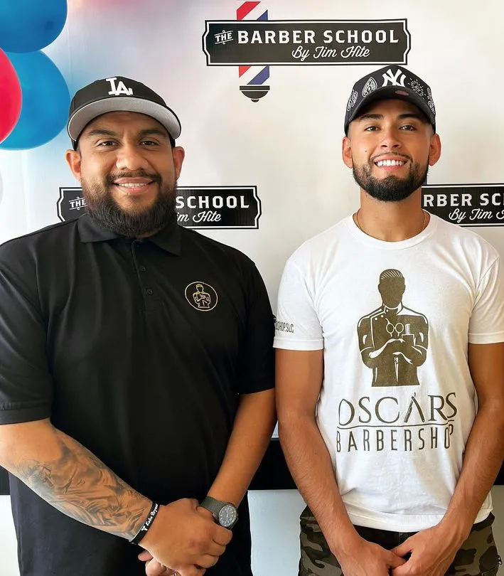 Oscar Ruiz and Christian teaching a barber class